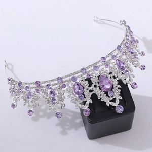 Macro shot of silver bridal crown featuring luxury purple crystals and rhinestones