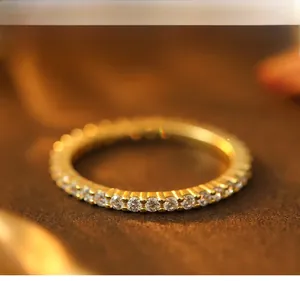 Macro detail of high-polish gold plated eternity ring with sparkling cubic zirconia stones