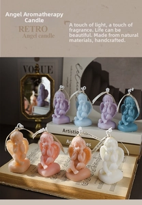 Macro view of detailed angel wings and prayer pose on handmade soy scented candles