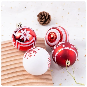 Detail of red and white 6cm Christmas balls with reindeer patterns on a wooden tray