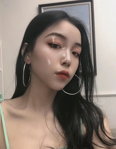 Close-up of a model wearing large silver-tone stainless steel hoop earrings in a minimalist style