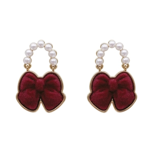 Elegant bow earrings with red flocking and white pearls on a gold-plated frame