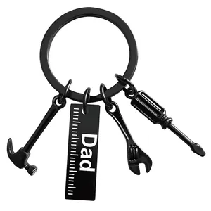 Close-up of black matte tool keychain with Dad ruler, hammer, screwdriver and wrench