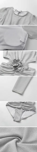 Close-up of silver glitter swimsuit featuring 3D fabric flowers and lace appliques