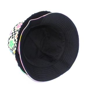 Close-up of double-sided bucket hat featuring floral print and black lining with stitching