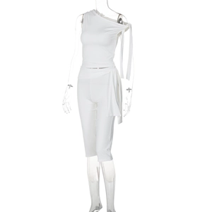 Detail of white one-shoulder sleeveless top and slim shorts set in stretch fabric
