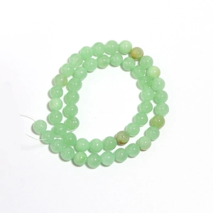 Detailed view of polished natural green jade round beads for DIY jewelry making