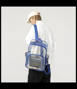 Side view of clear blue PVC backpack with mesh side pockets on a professional model