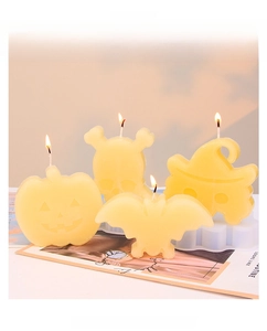 DIY Halloween scene display featuring skull, pumpkin, and bat scented candle models