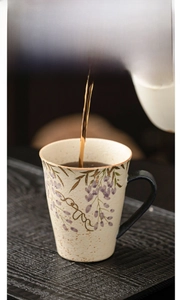 Detailed shot of wisteria ceramic mug with hand-painted gold rim and textured finish