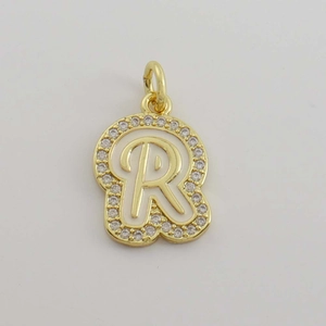 Detailed view of an 18K gold plated letter R pendant with cubic zirconia and white enamel