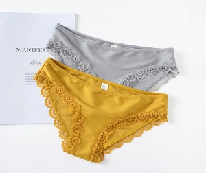 Flat lay of gray and yellow ribbed cotton panties with lace trim on a white background