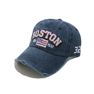 Detail of distressed navy washed cotton baseball cap with Boston and flag embroidery