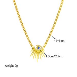 Irregular golden evil eye necklace with blue stone and crystals on cuban chain