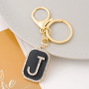 Macro detail of alphabet J keychain with sparkling rhinestones and gold lobster clasp