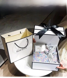 French white gift box with black ribbon and cute rabbit plush toy for Valentine's Day