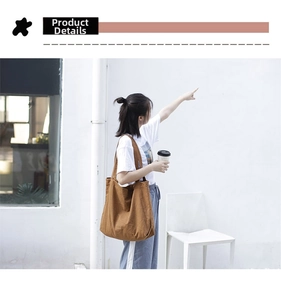 Detailed view of wide shoulder straps on a minimalist brown canvas tote bag for women