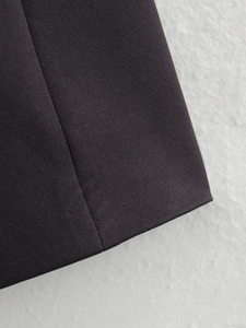 Detailed macro shot showing professional stitching and flat woven fabric of the blazer