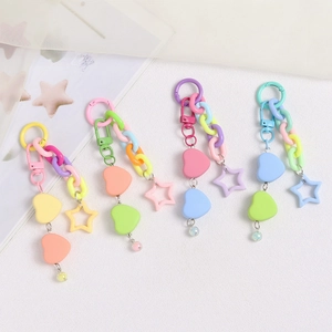 Detail view of colorful heart and star charms on acrylic keychains for bags and cases