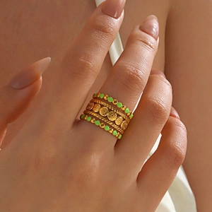 Bohemian gold stackable rings set with neon green enamel and sunflower patterns