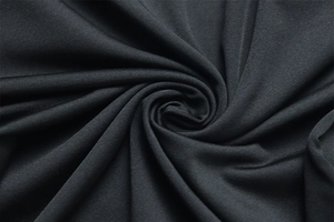 Macro detail of dark grey ruched knit fabric texture with silky finish and soft drape