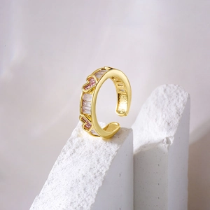 18K gold plated hollow heart ring with pink and white zircon stones on white stone