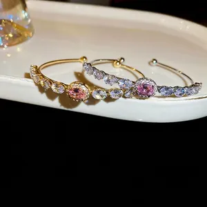 Elegant French-style gold and silver bangles with pink oval zircon and claw-set crystals