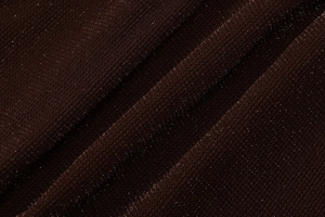 Macro shot of dark brown knit fabric featuring shimmering silver glitter and soft texture
