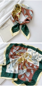 Detailed view of square silk scarf featuring autumn leaf and leopard print patterns
