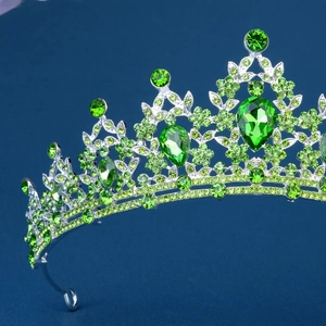Detail of silver bridal crown with green rhinestones and intricate leaf design