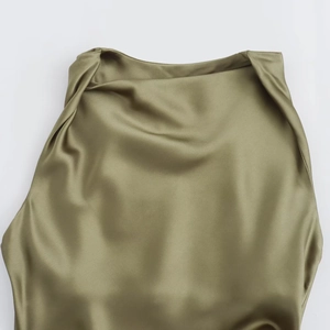 Detailed close-up of olive green satin sleeveless midi dress with elegant halter neckline