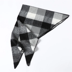 Detail of black and white checkered faux cashmere scarf with professional overlock stitching