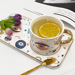 Ceramic evil eye coffee cup and tray set with golden spoon in lifestyle setting
