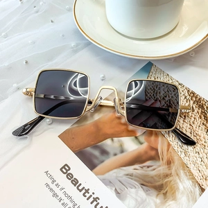 Close-up of gold metal frame sunglasses model 5055 with textured non-slip temple tips