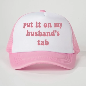 Pink and white trucker hat with 'put it on my husband's tab' slogan and mesh back