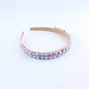 Fashionable crystal headband featuring iridescent leaf-shaped rhinestones on pink base