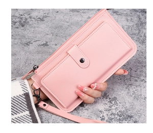 Pink long wallet with litchi texture being held by a model on grey background