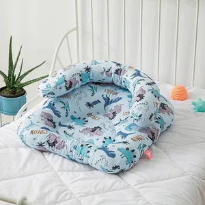 Blue cotton baby anti-startle sleep bed with colorful dinosaur prints and U-shaped support