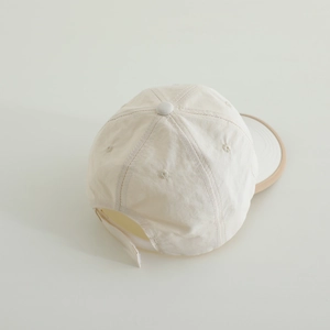 Rear view of breathable cream baseball cap with adjustable strap and contrast brim
