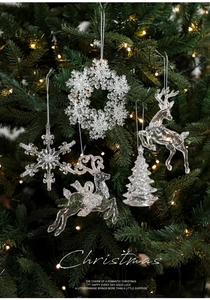 Close-up of clear acrylic Christmas ornaments including reindeer and snowflake shapes