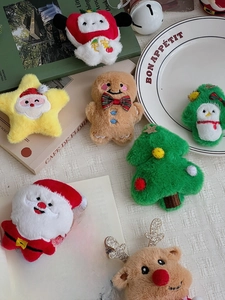Detailed view of assorted plush Christmas ornaments including Santa, reindeer, and tree