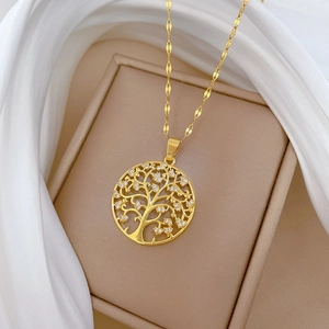 Macro detail of Tree of Life pendant with white cubic zirconia on gold necklace
