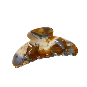Amber and grey marble acetate hair claw clip with colorful rhinestones on white backdrop