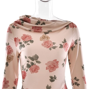 Close-up of the elegant turtleneck collar and detailed pink rose floral print on the top