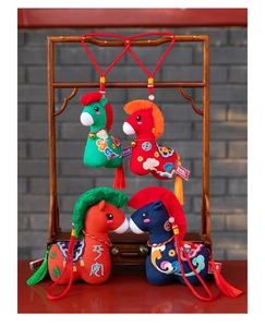 Detailed close-up view of four colorful traditional Chinese folk style plush horse mascots