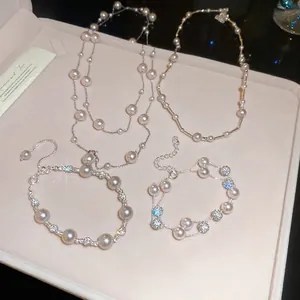 French retro pearl necklace and bracelet set with rhinestones on a pink velvet tray
