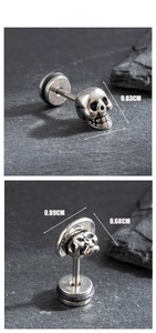 Detail view of vintage skull stud earrings showing precise dimensions and cast steel texture