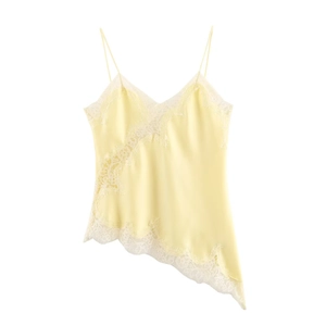 Close-up of pale yellow satin camisole with white lace trim and irregular hemline