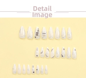Macro view of almond press-on nails with silver tribal lines and floral metal studs
