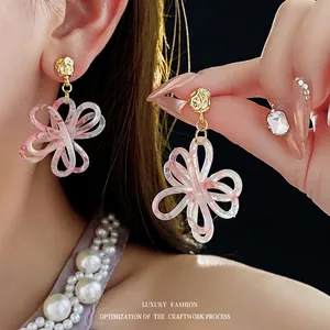 Pink and white resin flower drop earrings with golden metal studs for a chic vintage look